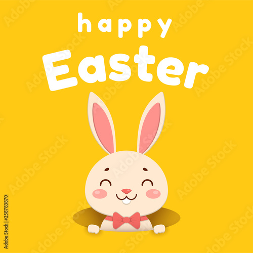 A cute cartoon bunny in a red bow tie is looking out of the hole and smiling. Isolated on yellow background.