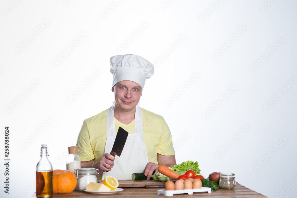 Male cook preparing dinner at the table Male cook preparing dinner at the table