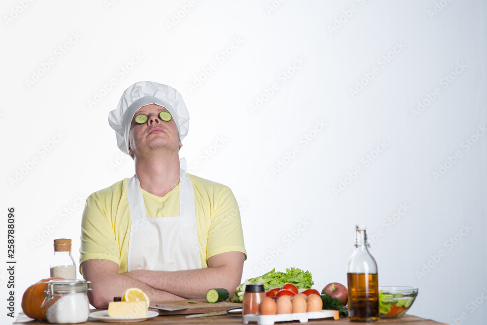 Male cook preparing dinner at the table