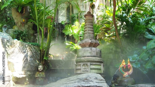 waterfall in the tropical garden of a buddhist temple