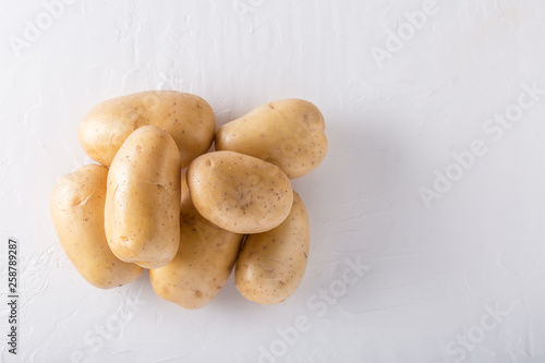 Raw organic potatoes on a white background