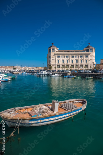 A colorful variety of boats and ships fill the docks of the harbors of Syracuse (Siracusa), a historic city on the island of Sicily, Italy.