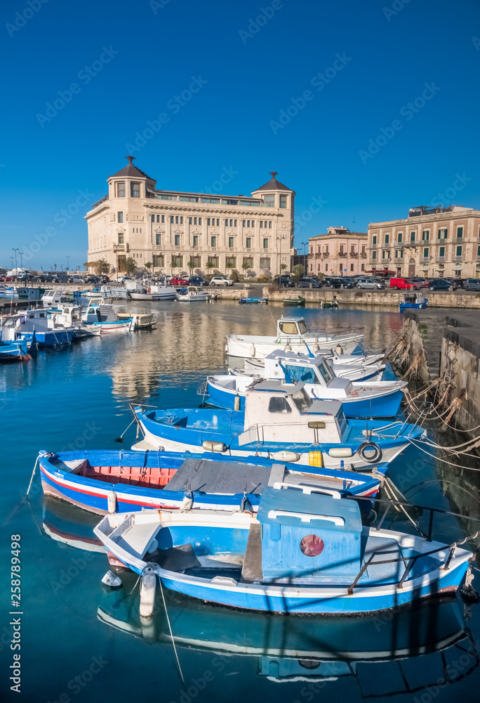 A colorful variety of boats and ships fill the docks of the harbors of Syracuse (Siracusa), a historic city on the island of Sicily, Italy.