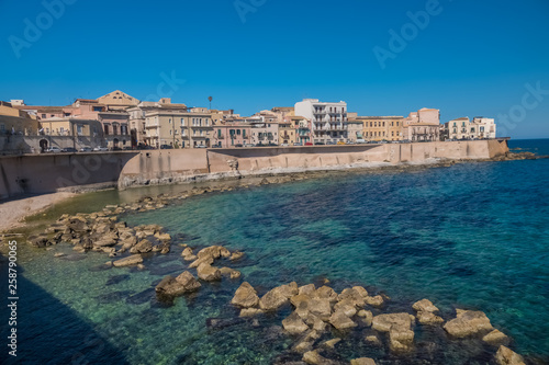 Fototapeta Naklejka Na Ścianę i Meble -  Eastern waterfront of Ortygia Island, Syracuse (Siracusa), a historic city on the island of Sicily, Italy. Notable for its rich Greek history, culture, amphitheatres, architecture