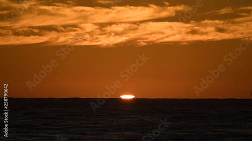 Green flash as the sun sets off the pacific coast in baja Mexico.  © buttbongo