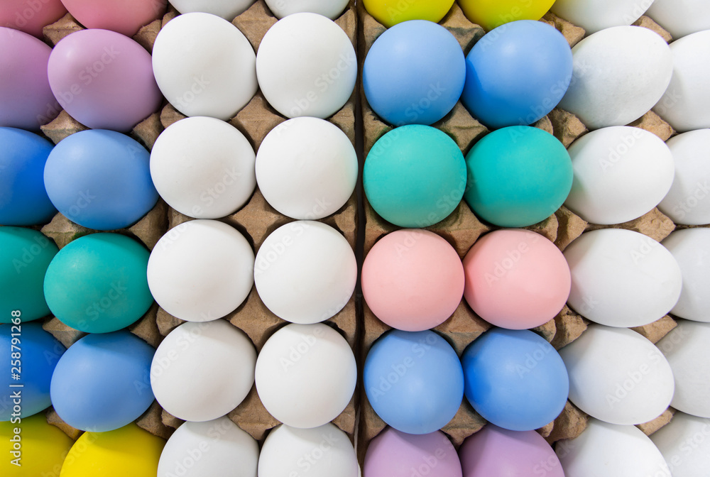 Colorful Easter egg in egg crate background pattern, flat lay view on a wide angle Colorful Easter egg in egg crate background pattern, flat lay view on a wide angle