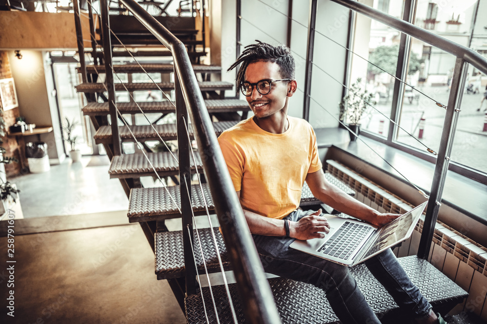 Young indian man sitting in coffeeshop table and working on laptop. The concept of study, freelancing, work, technology Young indian man sitting in coffeeshop table and working on laptop. The concept of study, freelancing, work, technology