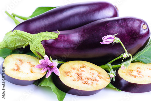 Fresh sliced eggplant. Eggplant close up. Slices of eggplant with greens. Eggplant bloom. Healthy eating concept.
