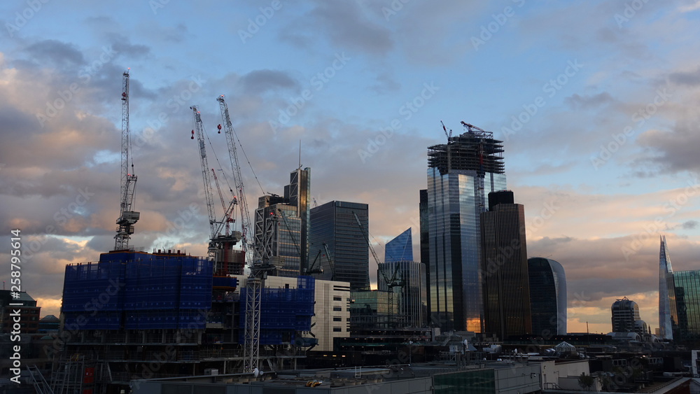 Photo from iconic modern skyscrapers in business district of Bank as seen from rooftop at dusk with beautiful clouds, London, United Kingdom