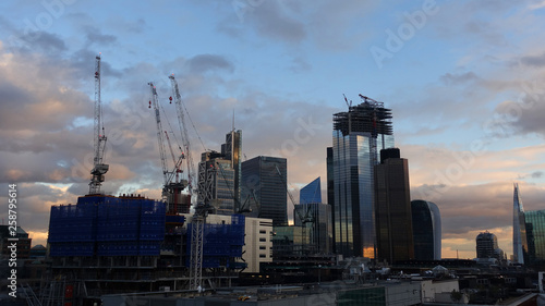 Photo from iconic modern skyscrapers in business district of Bank as seen from rooftop at dusk with beautiful clouds, London, United Kingdom