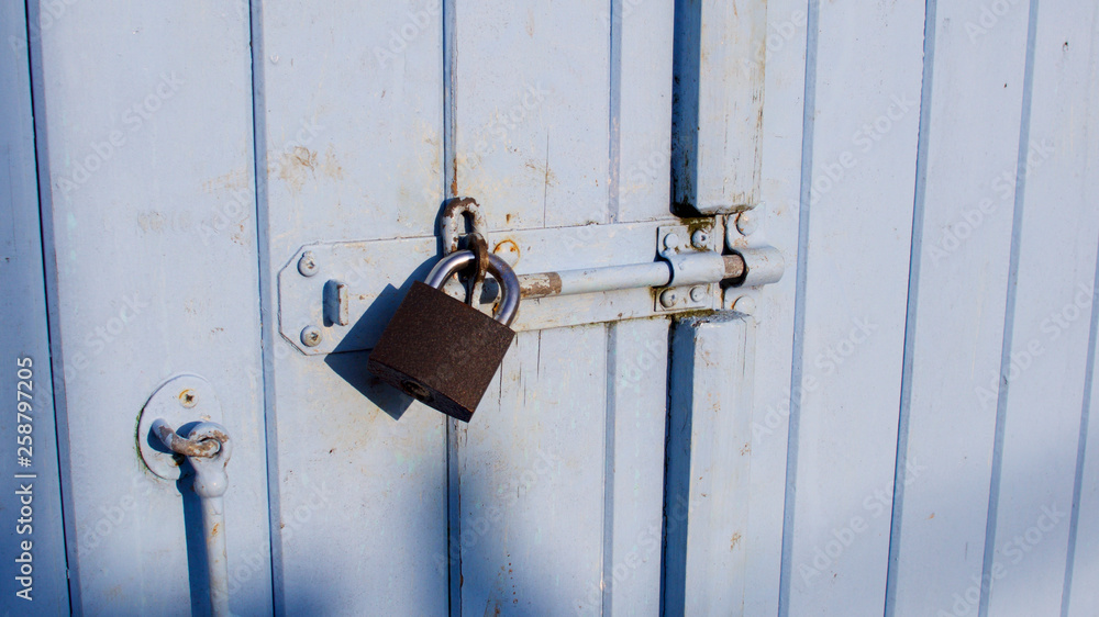 Pad-locked fisherman's quayside store room door Pad-locked fisherman's quayside store room door