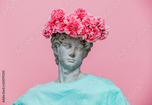 Antique bust of male with carnations bouquet in a hat photo