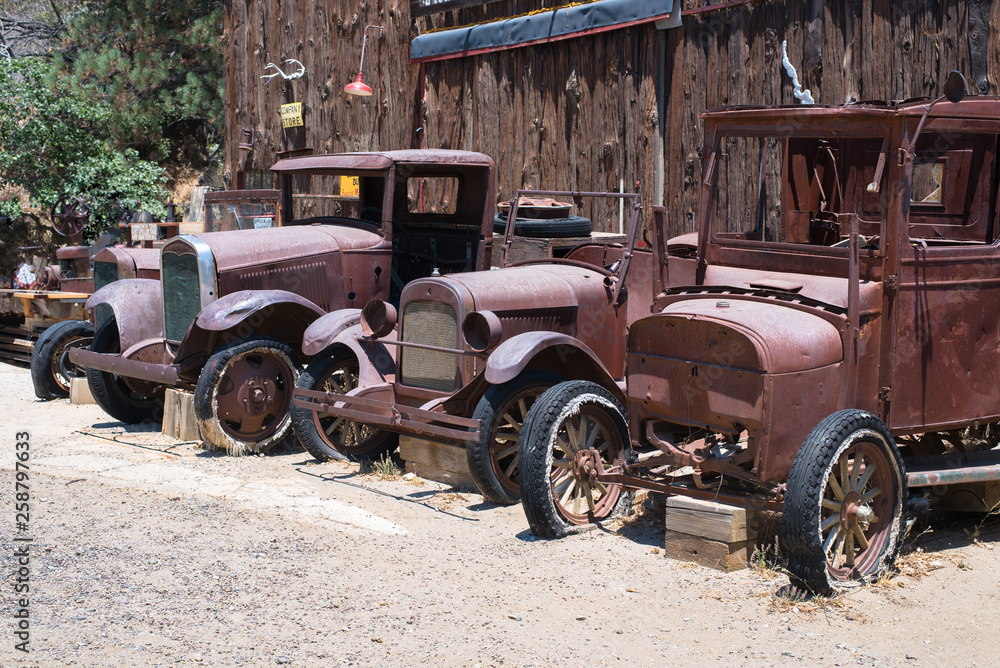 Obraz premium Three Rusty Old Trucks all in a Row