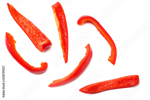 Tela cut slices of red sweet bell pepper isolated on white background top view