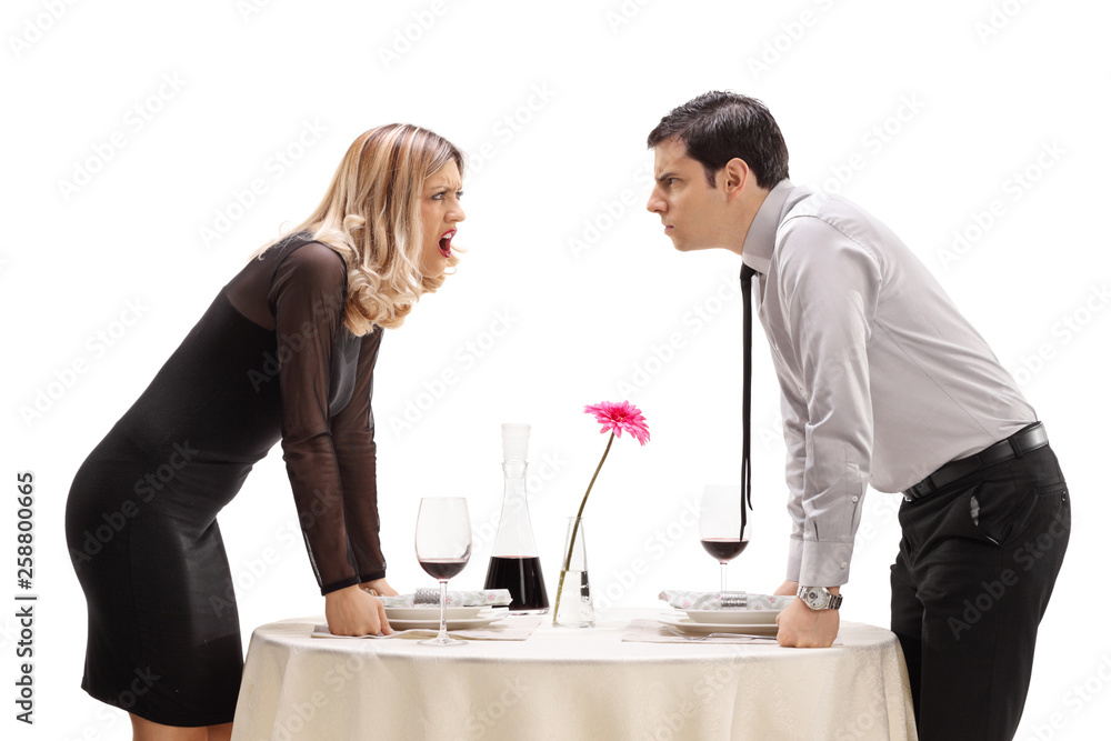 Young man and woman having an argument at a restaurant table Young man and woman having an argument at a restaurant table