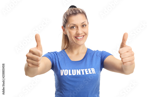 Young female volunteer showing thumbs up and smiling at the camera © Ljupco Smokovski