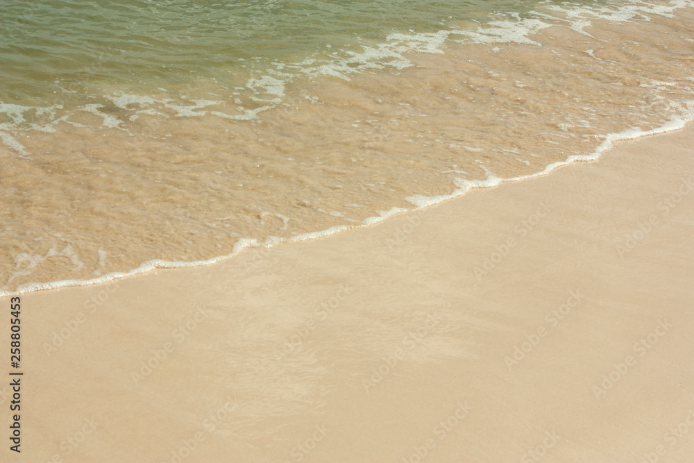 Soft wave of blue ocean on sandy beach. Background
