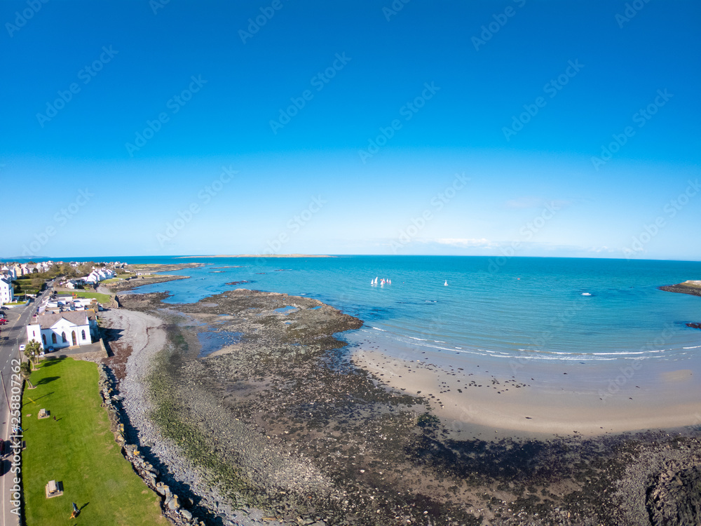 Aerial view of Beach and coast of Irish Sea in Donaghadee in Northern Ireland against clear blue sky. 