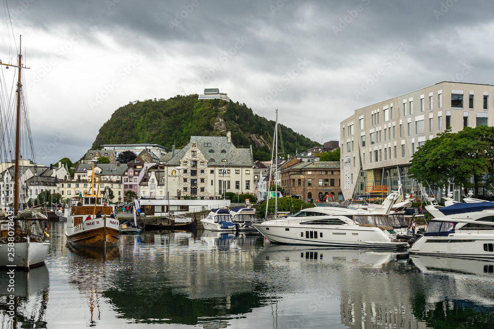 The picturesque Alesund inner harbor (Brosundet canal) with mount Aksla in the background, More og Romsdal, Norway