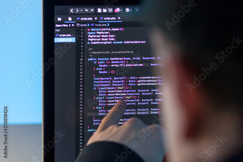 Programmer working on laptop computer in office