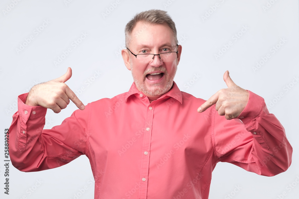 Senior man in red shirt and glasses is proud Senior man in red shirt and glasses is proud