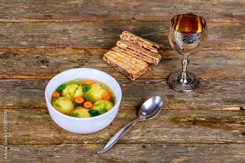 Hot Homemade Matzo Ball Soup in a Bowl Passover wine and matzah photo