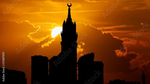 Mecca Clock Tower, Skyline in Silhouette with Abraj Al Bait, Time Lapse at Sunset, Saudi Arabia photo