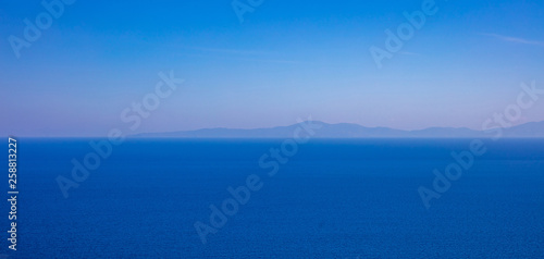 Greece. Aegean sea. Blue sky and calm sea water texture background