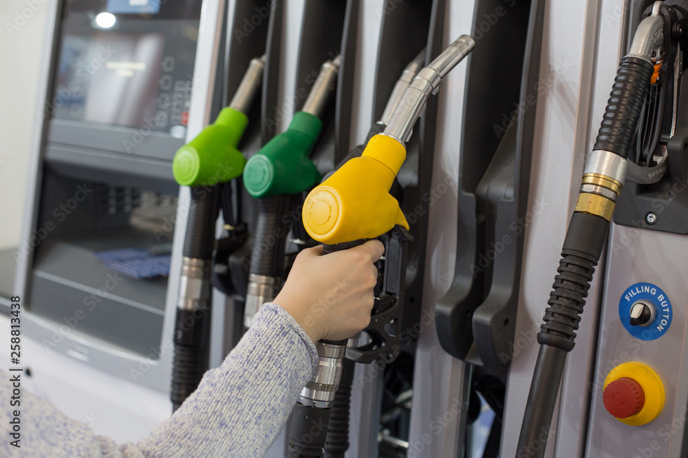 Woman filling petrol at station Woman filling petrol at station