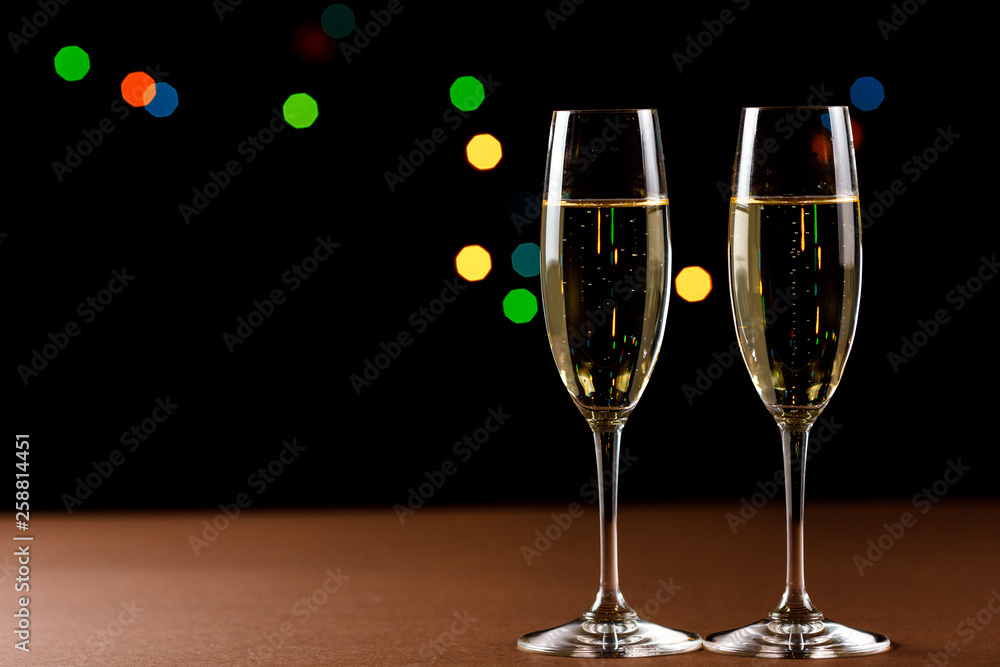 Champagne glasses on black background. Holiday celebration concept. Champagne glasses on black background. Holiday celebration concept.