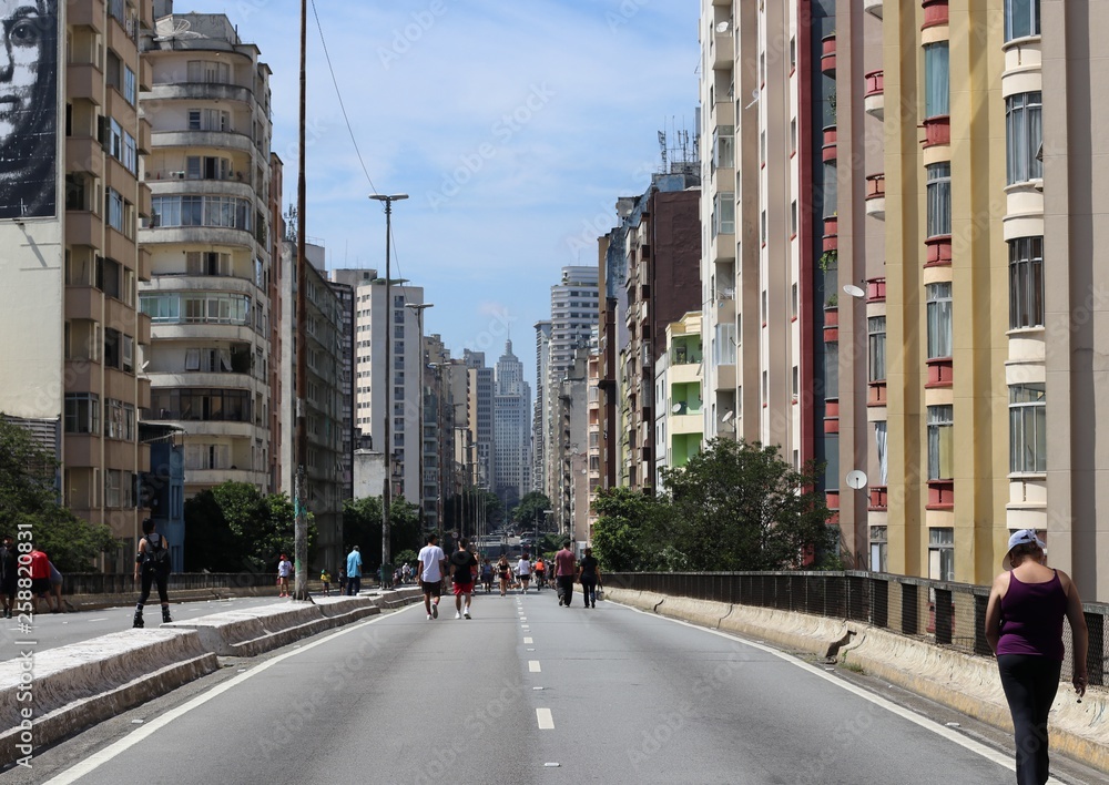 People walk around enjoying the sun and the scenery 