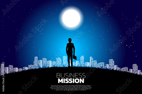Silhouette of businessman with briefcase standing in the moon and star. Concept of business mission vision and goal.