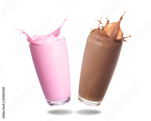 Fototapeta Strawberry milk and chocolate milk splashing out of glass isolated on white background