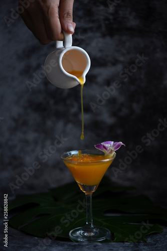 orange cocktail pouring in ...