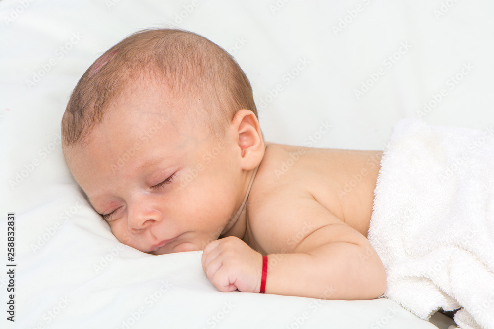 picture of a newborn baby curled up sleeping on a blanket picture of a newborn baby curled up sleeping on a blanket