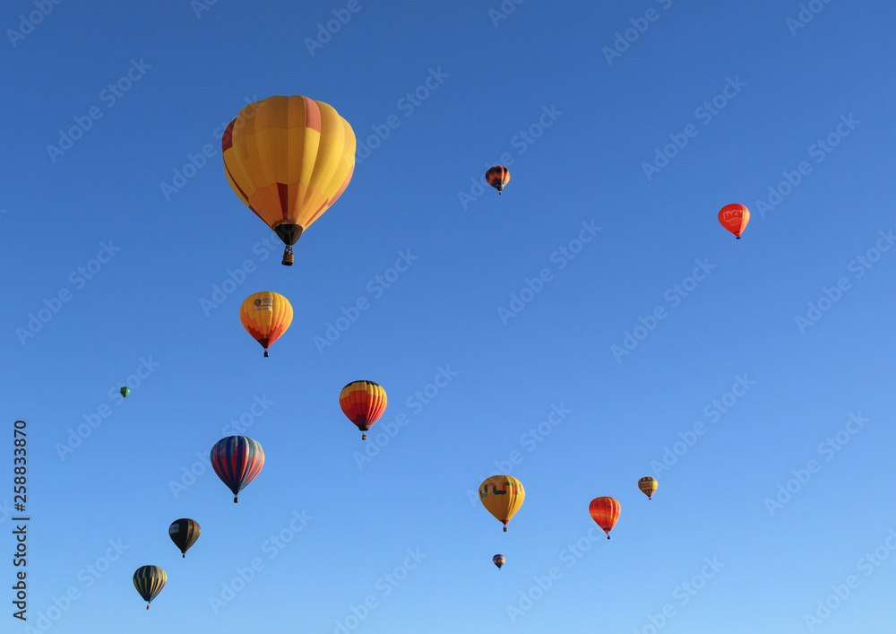 Colorful hot air balloons against a blue sky background
