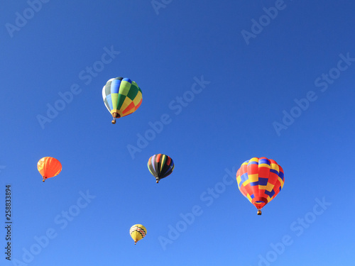 Colorful hot air balloons with blue sky in background