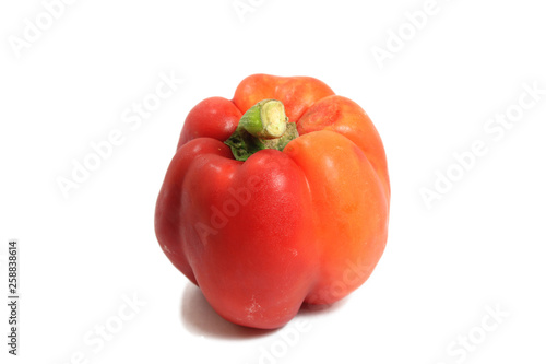 Red fresh bell pepper on background isolate.