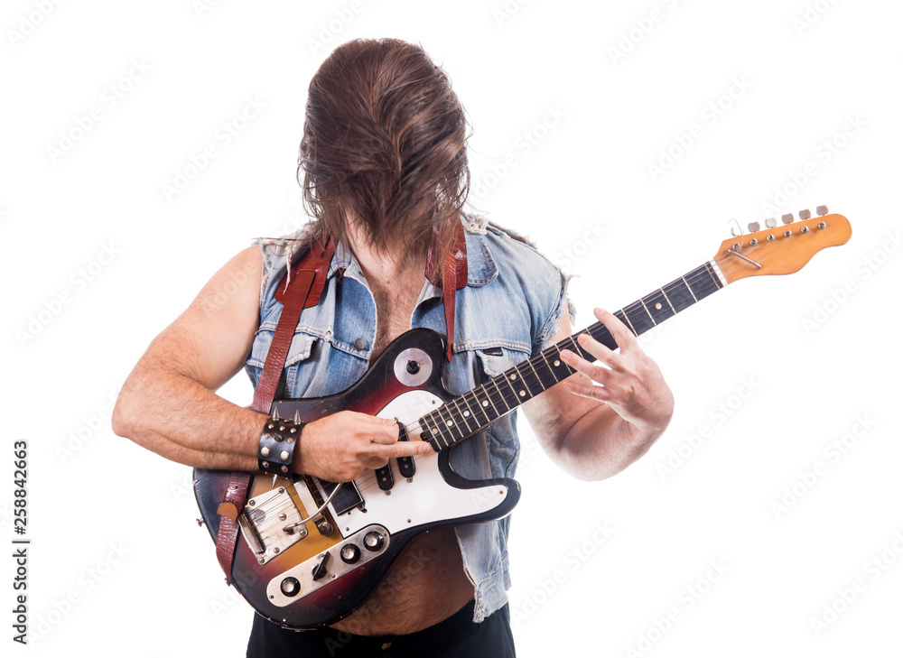 Excited guitarist in jeans jacket, isolated on white background..Man with hidden face from own flying hair play at electric guitar. Excited guitarist in jeans jacket, isolated on white background..Man with hidden face from own flying hair play at electric guitar.