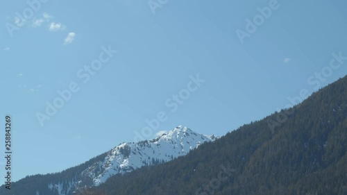4K established timelapse of mountain view in europe germany with snow and forest and clouds chemtrails