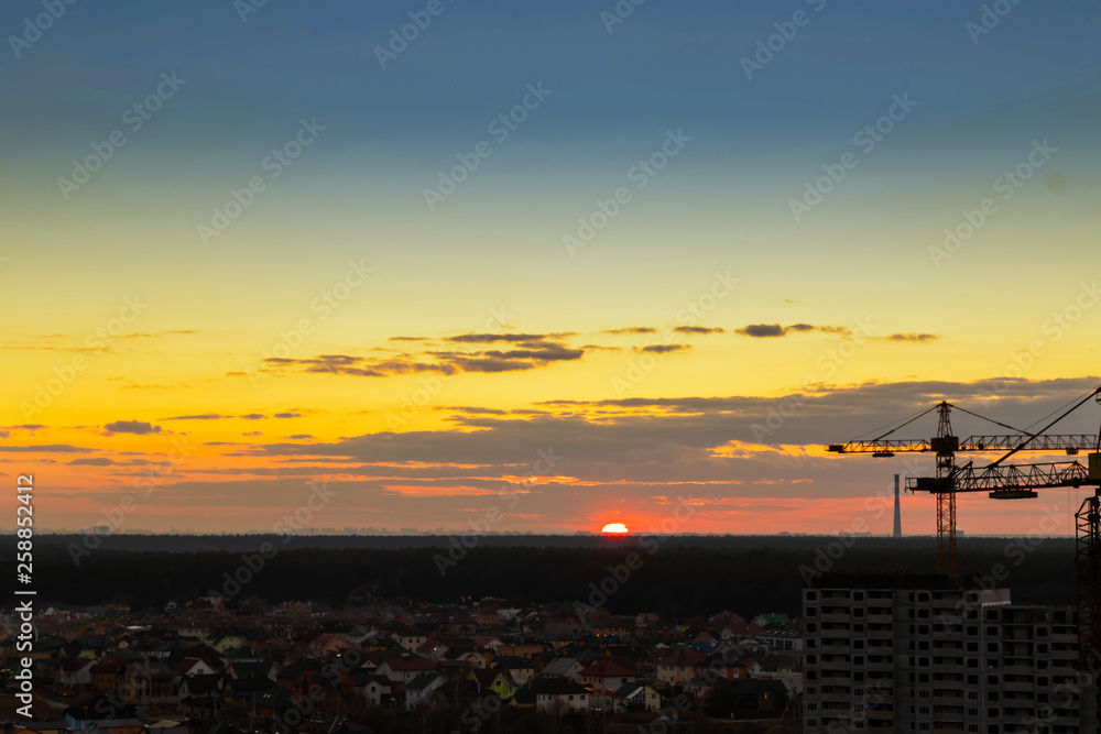 Construction tower crane,Industrial construction cranes on amazing sunset sky background