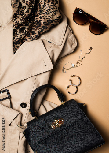 Fotografie Women fashion clothes and accessories flat lay, beige trench coat with bag, glas