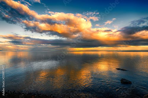 Fantastic Sunset Clouds over Ocean with Reflections