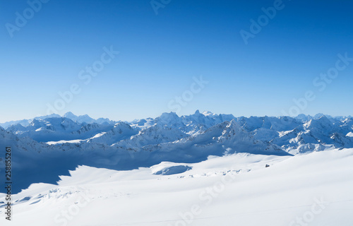 Snowy peaks of Caucasian Mountains in the blue sky. Elbrus region