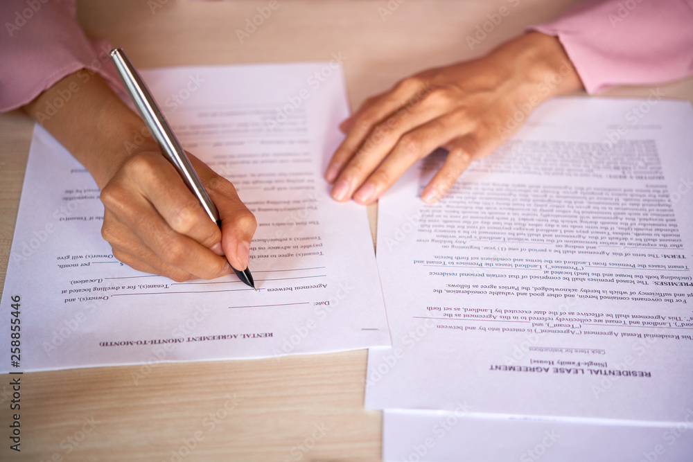 Woman filling rental agreement Woman filling rental agreement