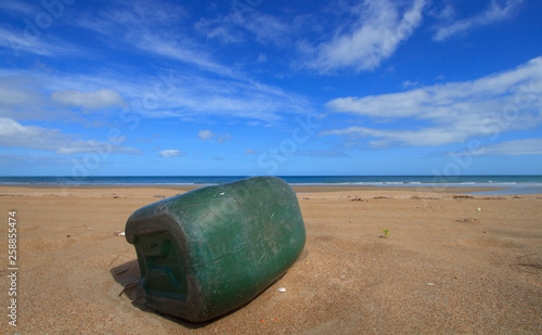 Green plastic drum dumped on Cape York beach with copy space