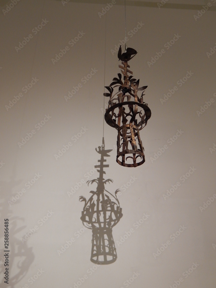  Vintage beautiful lamp and its patterned shadow on the white wall