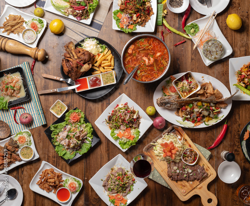 Set of thai food on table, Steak, Fish, Vegetables and Spices on a wooden
