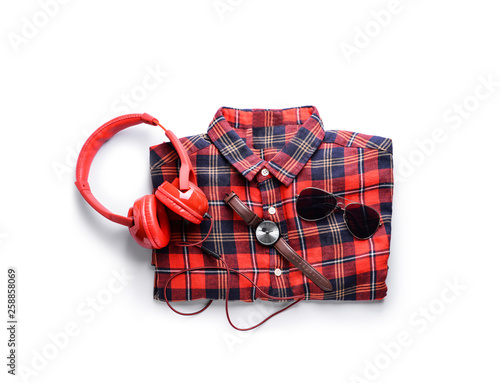 Shirt with headphones and accessories on white background