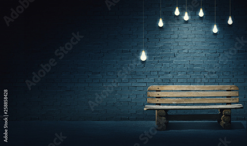Mixed media illustration of single wooden bench in front of brick wall under the light of lightbulbs. Late evening on the streets with quite place for solitude. 